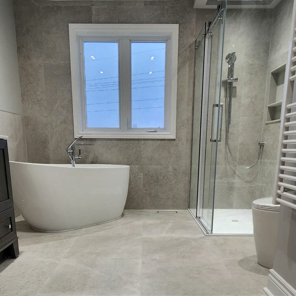 Interior shot of a bathroom with standing glass shower stall and freestanding tub